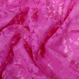 close-up of a pink floral stretch lace mesh fabric, detailing the mesh fabric structure and floral motif