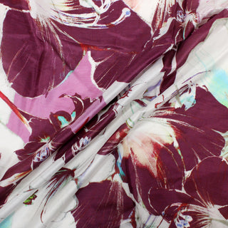 three diagonal lines draped of a magenta multicolor floral silk mikado fabric