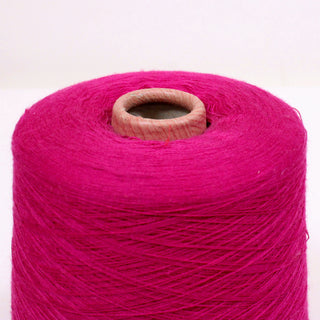 close-up of a cone of magenta colored ultra-fine luxurious yarn