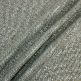 three lines draped diagonally of matcha colored woven-diamond upholstery fabric, detailing the heavy hand and textural face