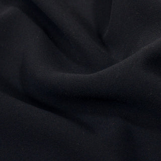 close-up of a matte, navy blue crepe fabric, detailing its crepey texture and weave