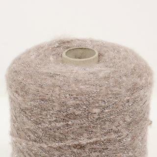 close-up of a cone of mauve grey lurex yarn showing the detailed texture of the fibers