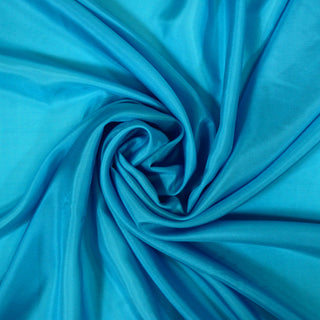 swirl of a bright aqua blue silk habotai fabric