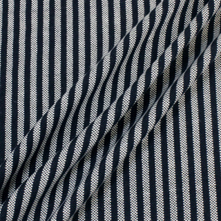 three diagonal lines arranged on a navy and white striped basketweave suiting fabric to demonstrate its moderate drape and matte surface