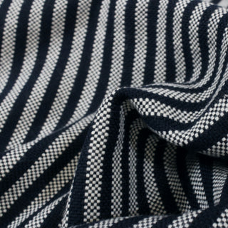 close-up of a navy and white striped basketweave suiting fabric, detailing its weave and face