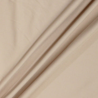 pale nude colored spandex knit lining fabric with three arranged folded peaks on its surface to demonstrate the weight and structure of the fabric