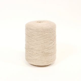 cone of oat colored fine-gauge yarn of natural fibers