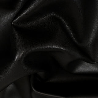 close-up of a black apparel pleather fabric, detailing the faux texture