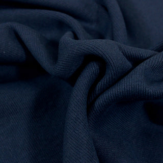 close-up of dark ocean blue colored rib-knit jersey fabric, detailing its knit structure