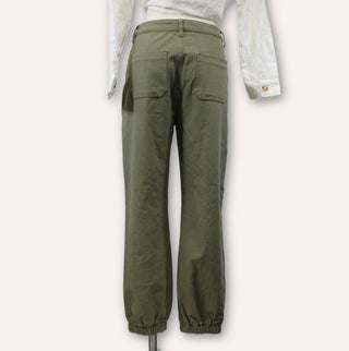 back view of olive green pants on a mannequin