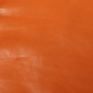 smooth face of a vibrant orange cowhide leather