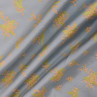 three diagonal lines draped of a pastel colored floral jacquard twill fabric with a light blue ground