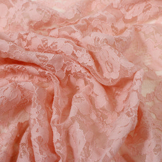 close-up of a pink floral stretch lace mesh fabric, detailing the mesh fabric structure and floral motif