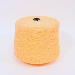 large cone of peach fuzz colored eyelash yarn