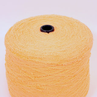 close-up of a large cone of peach fuzz colored eyelash yarn, detailing its texture