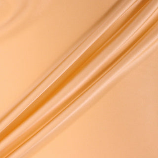 three diagonal lines draped of a peach colored stretch-silk charmeuse fabric