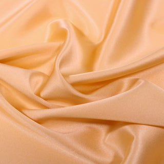 Close-up of peach-colored fabric with folds