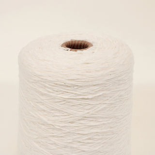 close up of a cone of pearl white colored ladder yarn of a fine-gauge