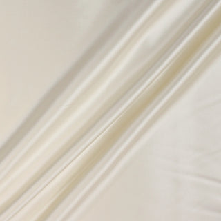 white pearl colored silk mikado fabric, arranged with three diagonal peaks to demonstrate the shiny face and drapability