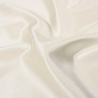 close-up of white pearl colored silk mikado fabric, detailing the twill weave and shiny face