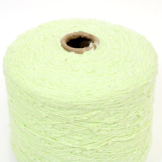 close-up of a large cone of pale pear colored slub yarn