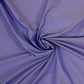 swirl of a periwinkle colored poplin fabric demonstrating the drape and hand