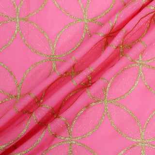 three draped lines of bright pink voile fabric with gold lurex threads woven in to create a flower of life pattern