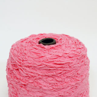 close-up of a cone of pink textured yarn