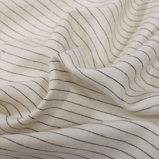 close-up of an ivory wool pinstripe suiting fabric