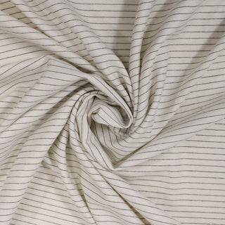 swirl of an ivory pinstripe wool suiting fabric, demonstrating the lightweight hand and drapability 