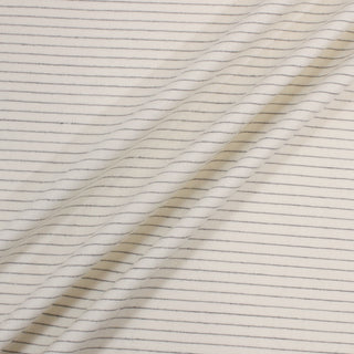 three diagonal lines draped of an ivory wool suiting fabric with navy pinstripes woven throughout