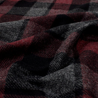 close-up photo of flannel plaid fabric ruffled to show weave detail and quality of hand