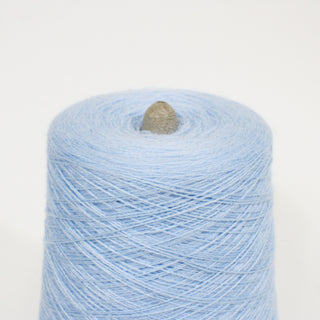 close-up of a cone of powder blue colored laceweight acrylic yarn