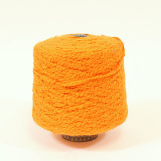 cone of pumpkin colored bulky boucle yarn