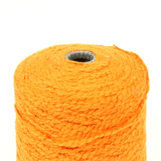 close-up of a cone of pumpkin colored bulky boucle yarn