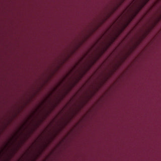 rumpled raspberry tricot knit fabric demonstrating the drape