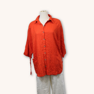 front of a red-orange button up shirt