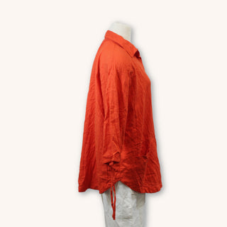 side of a red-orange button up shirt