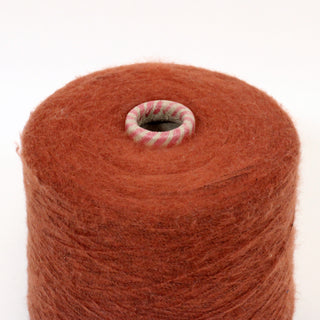 close-up of a cone of fuzzy, fine-gauge, redwood colored yarn