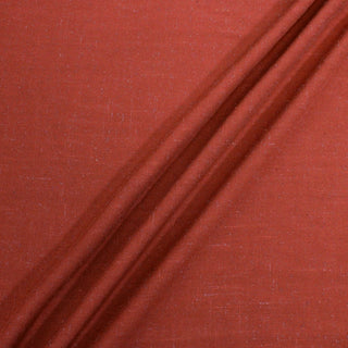 bunching of rust slub hopsack fabric to show dimensionality and drape
