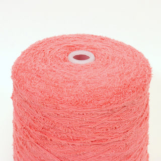 close-up of a cone of salmon pink colored eyelash yarn