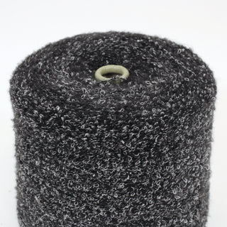 close-up of a cone of black and white speckled lightweight textured boucle yarn