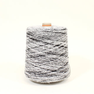 mid-size cone of black and white colored curly slub yarn of a fine gauge