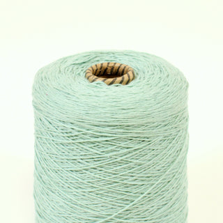 close-up of a cone of seafoam colored core yarn