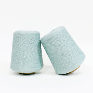 two cones of seafoam colored ultra-fine yarn