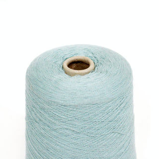 close-up of a cone of seafoam colored ultra-fine yarn