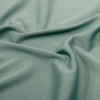 close-up image of seaglass colored tricot knit detailing the knit structure and gentle drape