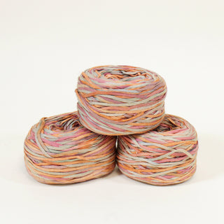 pyramid of three balls of sherbert colored ribbon yarn