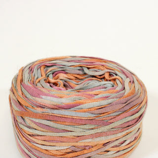 close-up of a ball of sherbert colored ribbon yarn