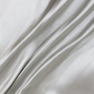 lines arranged on silver silk serge-woven fabric to demonstrate its movement and shine